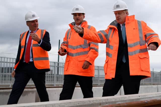 Boris Johnson 9right) pledged to build Northern Powerhouse Rail during a visit to Manchester three days after taking office.