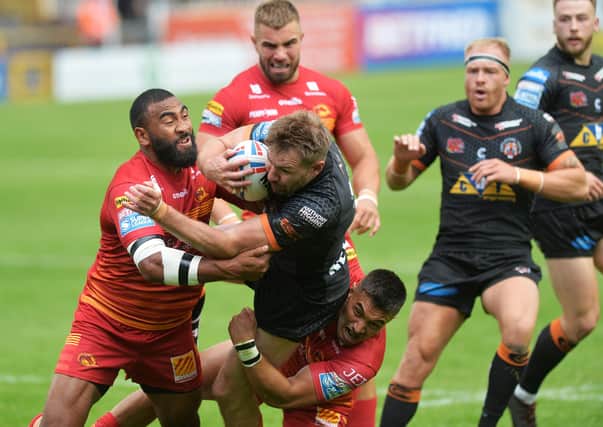 Castleford Tigers' Michael Shenton is stopped by the Catalans defence. Picture: Jonathan Gawthorpe