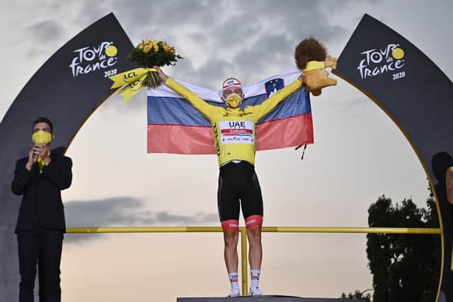 Team UAE Emirates rider Slovenia's Tadej Pogacar wearing the overall leader's yellow jersey celebrates on the podium after winning the 107th edition of the Tour de France cycling race (Picture: ANNE-CHRISTINE POUJOULAT/AFP via Getty Images)