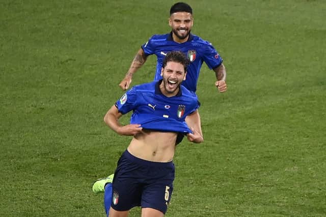 Italy's Manuel Locatelli celebrates with his teammate Lorenzo Insigne after scoring his side's first goal against the Swiss. Picture: AP Photo/Riccardo Antimiani, Pool