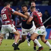On a charge: Wakefield Trinity's David Fifita drives at Wigan Warriors' Liam Byrne and Eddie Battye.
