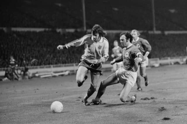 Going through: Mick Channon takes on the West Germany captain.