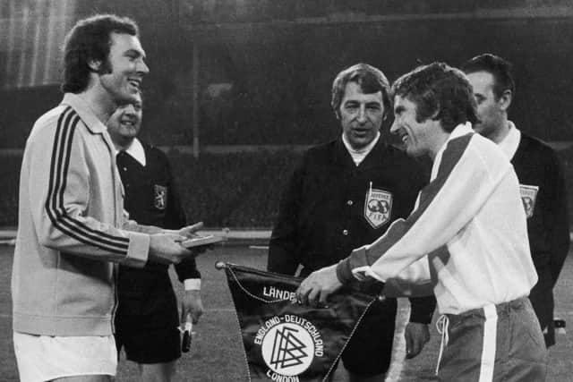 Friendly rivals: England's captain Alan Ball exchanging pennants with Franz Beckenbauer.