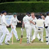 Out: Mark Robertshaw of Pudsey St Lawrence is surrounded by Farsley players after being caught by Ran Cooper for 0 off the bowling of Mathew Lumb in the Bradford League. Pictures: Steve Riding