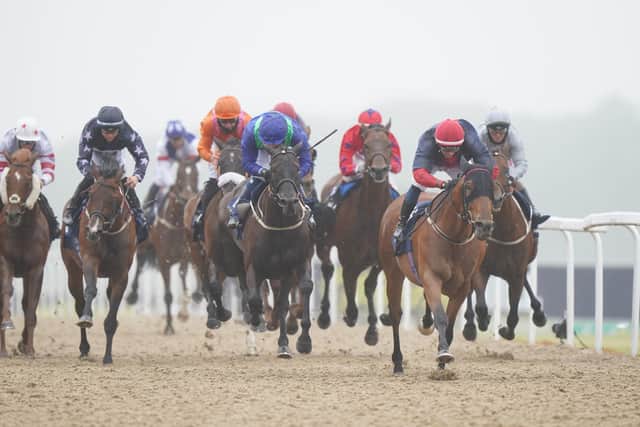 Ben Robinson on Nicholas T, (red/white cap, blue top) on their way to winning the William Hill Northumberland Plate
