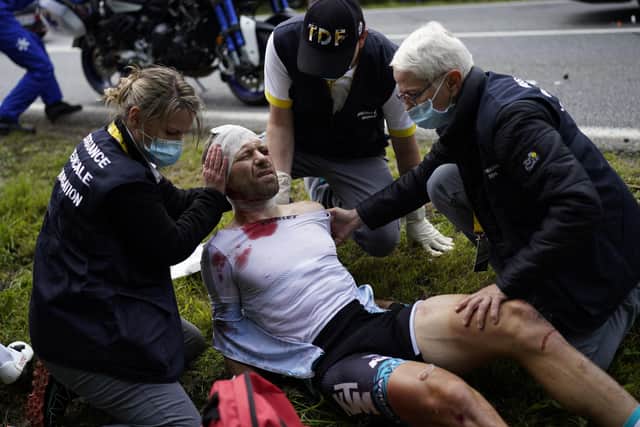 France's Cyril Lemoine gets medical assistance after crashing during the first stage of the Tour de France cycling race over 197.8 kilometers (122.9 miles) with start in Brest and finish in Landerneau, France on Saturday. (AP Photo/Daniel Cole)