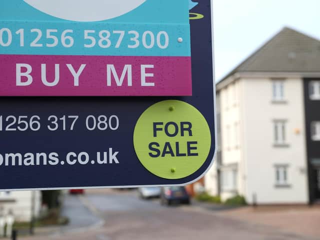 Library image of  an estate agent's board outside a house for sale