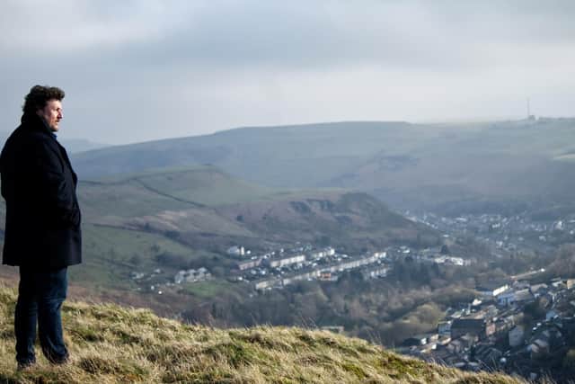 Michael standing looking over the valleys where his family came from. Picture: PA Photo/Wildflame Productions