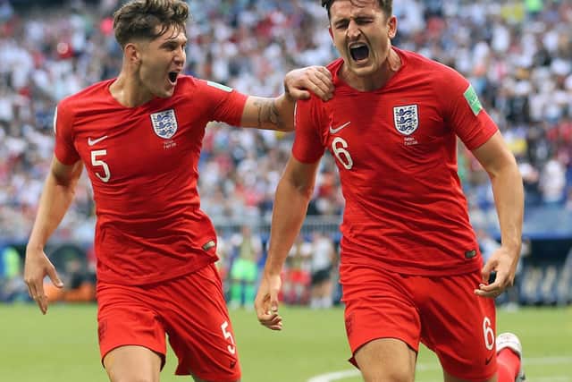 IN TANDEM: John Stones (left) and Harry Maguire excelled alongside Kyle Walker at the 2018 World Cup