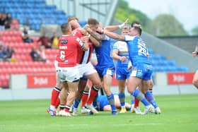 Sunday scrap: Players for Salford Red Devils and Leeds Rhinos come together in last weekend's staormy encounter. Picture: Steve Riding