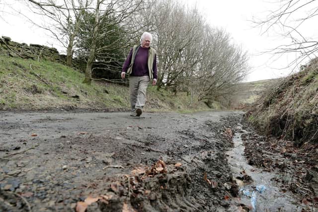 Holme Valley South councillor Donald Firth inspects damage to a green lane route used by bikers and 4×4 drivers.