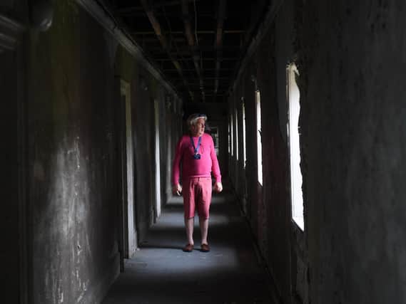 Tour guide David Allott in 'Bedlam', a corridor of bedrooms