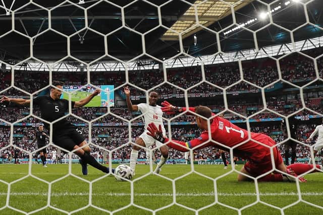England's Raheem Sterling, centre,, scores England's opener against Germany. (AP Photo/Frank Augstein)