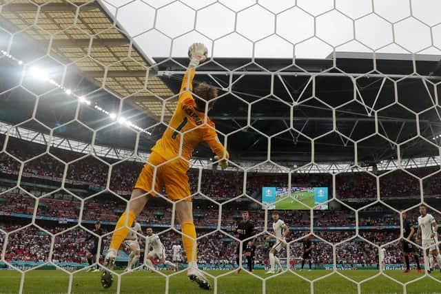 England's goalkeeper Jordan Pickford stops a shot from Germany's Kai Havertz, background left. (AP Photo/Frank Augstein)