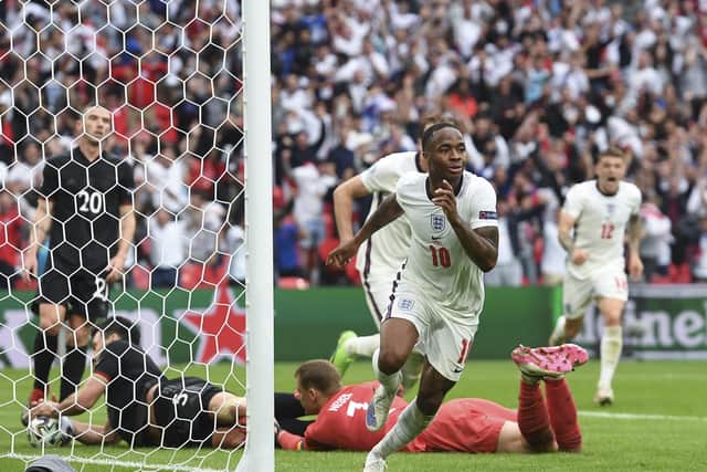 England's Raheem Sterling celebrates after scoring his side's opening goal against Germany. (Andy Rain, Pool via AP)
