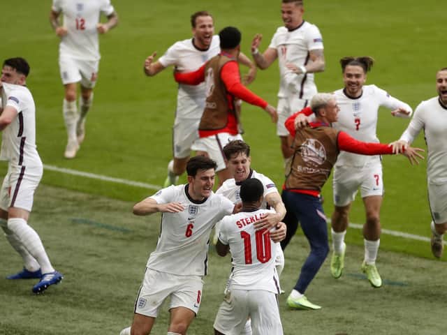 England's Raheem Sterling celebrates with teammates after scoring his side's first goal during the Euro 2020 soccer championship round of 16 match between England and Germany, at Wembley stadium, in London, Tuesday, June 29, 2021. (Matthew Childs/Pool via AP).