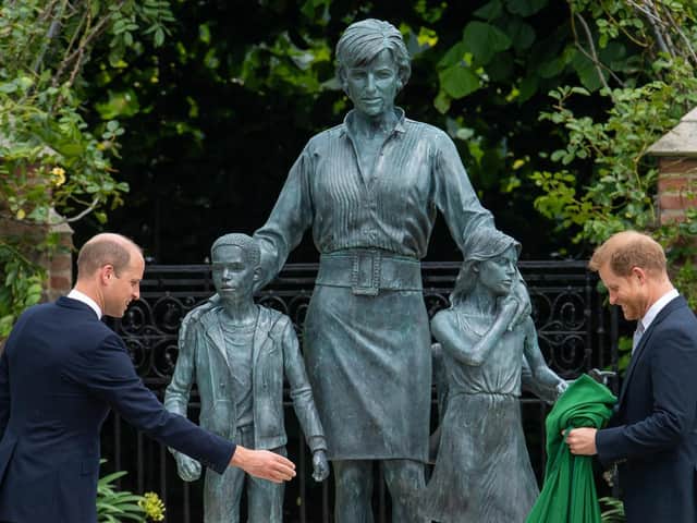 The Duke of Cambridge (left) and Duke of Sussex look at a statue they commissioned of their mother Diana, Princess of Wales, in the Sunken Garden at Kensington Palace, London, on what would have been her 60th birthday. Picture: Dominic Lipinski/PA Wire