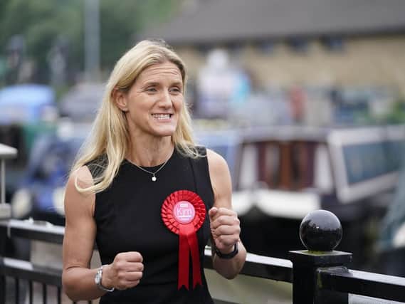Labour candidate Kim Leadbeater celebrates by a canal in Huddersfield after winning the Batley and Spen by-election