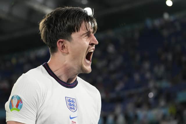 England's Harry Maguire celebrates after scoring his side's second goal during the Euro 2020 soccer championship quarterfinal match between Ukraine and England. (AP Photo/Alessandra Tarantino, Pool)