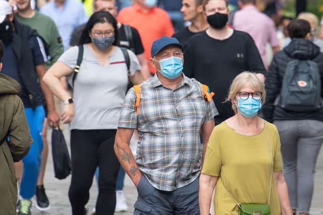 People wearing face masks among crowds of pedestrians in Covent Garden, London. Picture: Dominic Lipinski/PA Wire