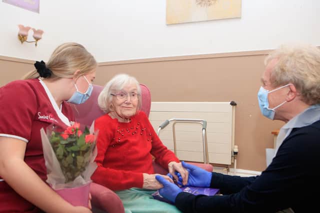 Mike Padgham (right) visits his 93-year-old mother Phyllis Padgham (centre) with Activities Assistant Charlotte Henderson (left) at St Cecilia's Nursing Home in Scarborough, North Yorkshire, in March this year. Photo credit: Danny Lawson/PA