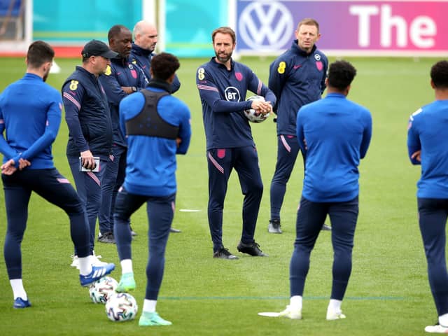 DECISIONS, DECISIONS: England manager Gareth Southgate speaks to his players during a training session at St George's Park. Picture: Nick Potts/PA