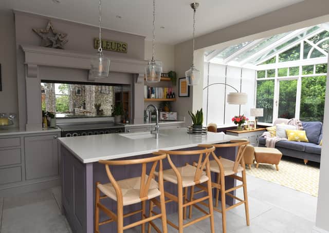 he renovated and opened-up kitchen. The island is painted in Farrow & Ball Brassica and th the floor tiles are from Lapicida. Picture Gerard Binks