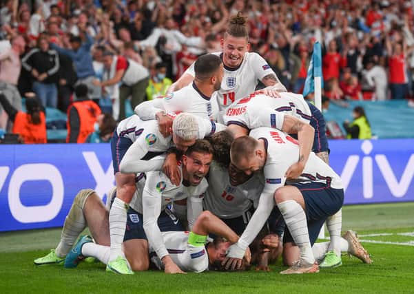 Harry Kane of England (obscured) celebrates with team mates after scoring the winning goal. (Photo by Laurence Griffiths/Getty Images)