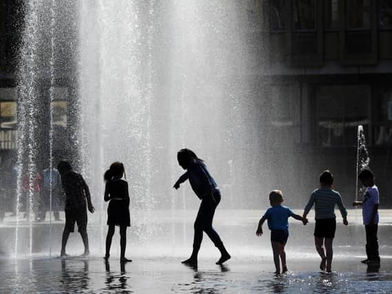 Children playing in the fountains in City Park, Centenary Square, Bradford. Picture: Bruce Rollinson.