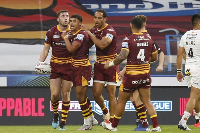 Huddersfield Giants' Will Pryce celebrates with Jake Wardle after assisting his try against Catalans Dragons. Picture by Ed Sykes/SWpix.com