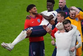 CREATOR: Bakayo Saka, being lifted by Tyrone Mings at full-time, put the cross in for England's opening goal