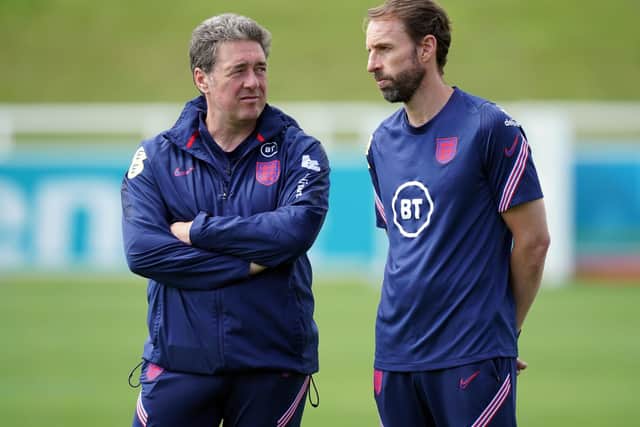Back to earth: England manager Gareth Southgate (right) alongside John McDermott at trainign yesterday. Picture: Mike Egerton/PA Wire.