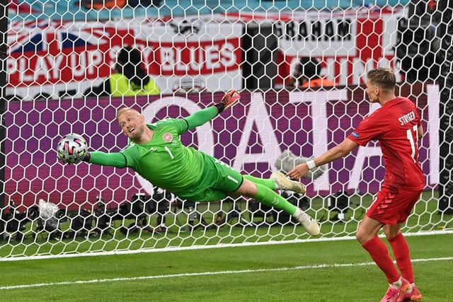 Denmark's Kasper Schmeichel makes a save from Harry Maguire. (Photo by Justin Tallis - Pool/Getty Images)