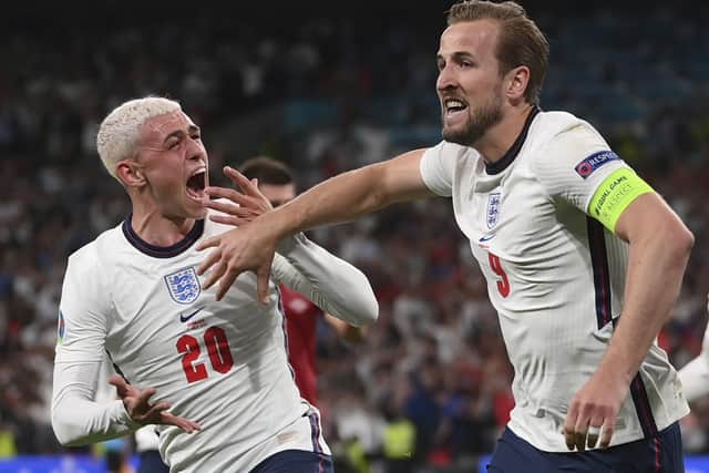 Get in: England's Harry Kane, right, celebrates his winning goal with Phil Foden. (Laurence Griffiths/Pool Photo via AP)
