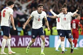 England's John Stones, center, Harry Maguire, left and Kalvin Phillips celebrate after beating Denmark in Wednesday night's semi-final. Picture: Andy Rain/AP