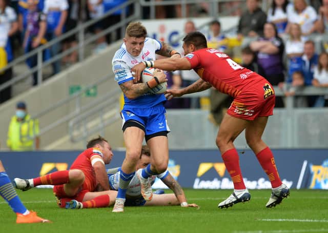 Leeds Rhinos' Liam Sutcliffe is tackled by Catalans' Dean Whare.  Picture: Jonathan Gawthorpe