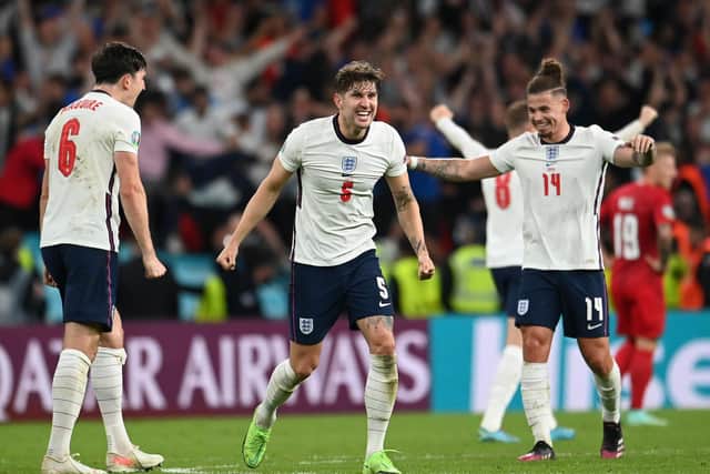 Harry Maguire, John Stones, and Kalvin Phillips of England celebrate following their team's victory in the UEFA Euro 2020 Championship Semi-final. (Photo by Andy Rain - Pool/Getty Images)