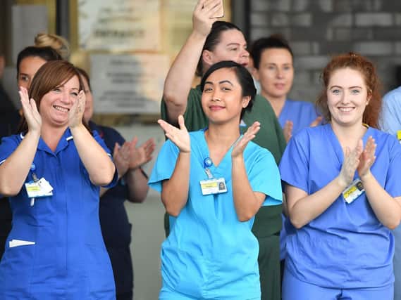 NHS workers participate in a national "clap for carers" event. Photo by Paul Ellis/AFP via Getty Images.