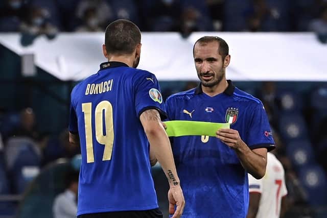 PARTNERS: Italy's Giorgio Chiellini, right, gives the captain's armband to teammate Leonardo Bonucci before leaving the pitch during the Euro 2020 clash against Switzerland. Picture: Andreas Solaro/AP