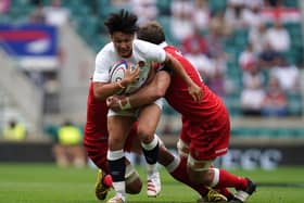 England's Marcus Smith (centre) tackled by Canada's Lucas Rumball (left) and Reegan O'Gorman during the Summer Series match at Twickenham Stadium, London. Picture date: Saturday July 10, 2021. PA Photo.Harlequins and England fly-half Marcus Smith has been called up by the British and Irish Lions as injury cover for Finn Russell, the Lions have announced. See PA story RUGBYU Lions. Photo credit should read: Andrew Matthews/PA Wire. 
RESTRICTIONS: Use subject to restrictions. Editorial use only, no commercial use without prior consent from rights holder.
