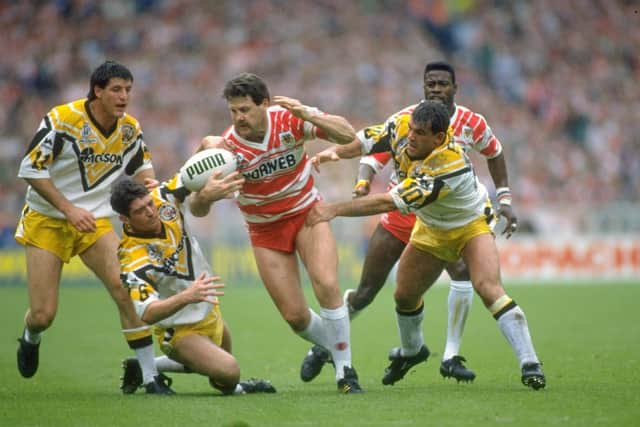 Gene Miles (centre) of Wigan is tackled by Keith England (right) of Castleford during the Challenge Cup final at Wembley Stadium in London. Wigan won the match 28-12.  (Picture: Bob  Martin/Allsport)