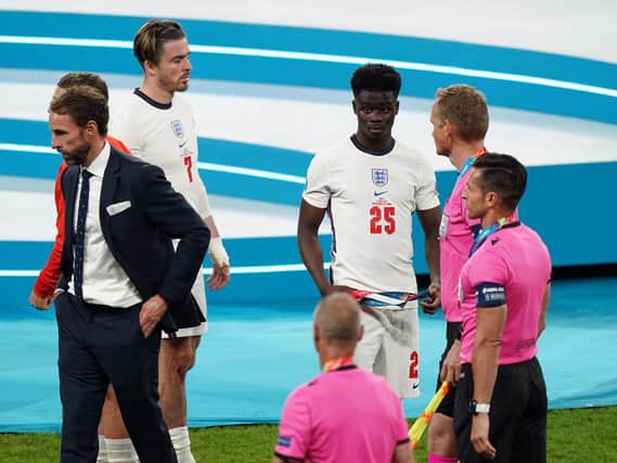 England's Bukayo Saka (25) alongside manager Gareth Southgate following the UEFA Euro 2020 Final