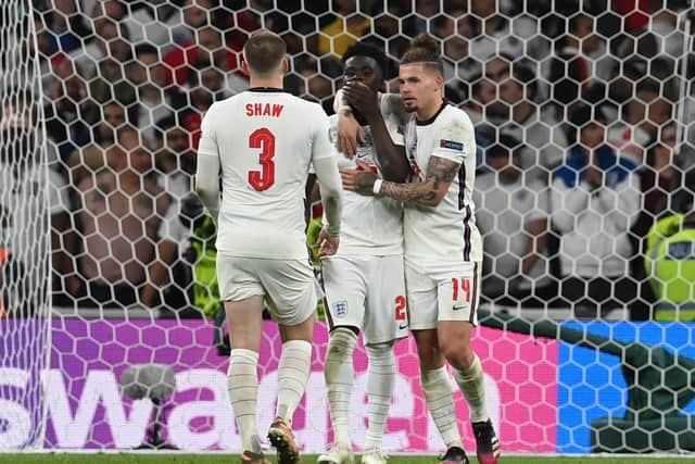 Bukayo Saka of England is consoled by Luke Shaw and Kalvin Phillips after missing their side's fifth penalty in the penalty shoot out . (Picture: Paul Ellis - Pool/Getty Images)