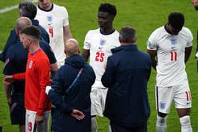England manager Gareth Southgate stands dejected alongside Bukayo Saka and Jack Grealish following the UEFA Euro 2020 Final