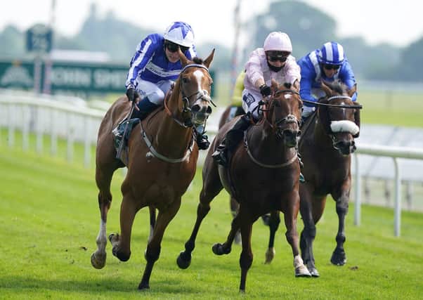 Johnny Drama and Joshua Bryan (left) coming home to win the John Smith's Cup Handicap at York on Saturday. Picture: Martin Rickett/PA