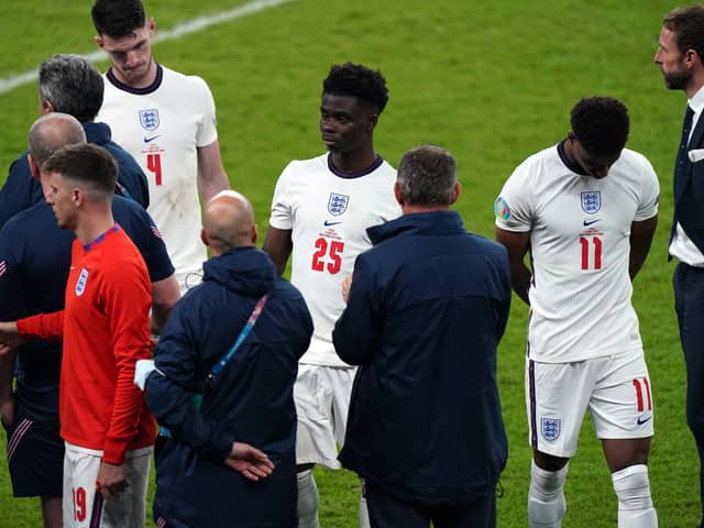 England manager Gareth Southgate stands dejected alongside Bukayo Saka and Marcus Rashford following the UEFA Euro 2020 Final at Wembley Stadium, London. (Picture: PA)
