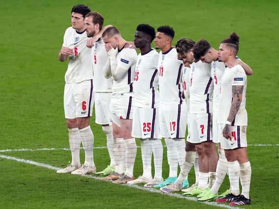 England's Jadon Sancho (17) and Bukayo Saka alongside team mates during the penalty shoot out following the UEFA Euro 2020 Final