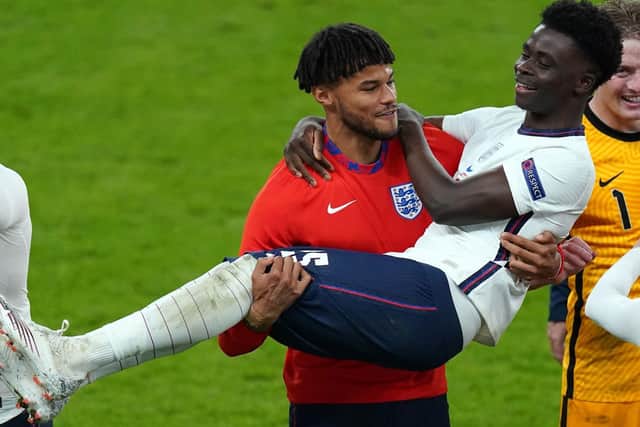 England's Tyrone Mings carries Bukayo Saka as they celebrate winning the UEFA Euro 2020 semi final match at Wembley Stadium, London. (Picture: PA)