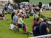 Visitors to the first day of the show relax in the fine weather to watch the showjumping in the main ring. . Picture Tony Johnson
