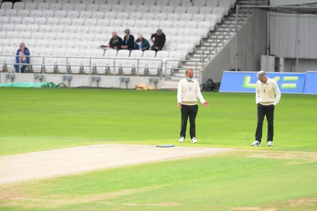 Umpires inspect the wicket before delaying the start of day three of Yorkshire v Lancashire (Picture: Steve Riding)